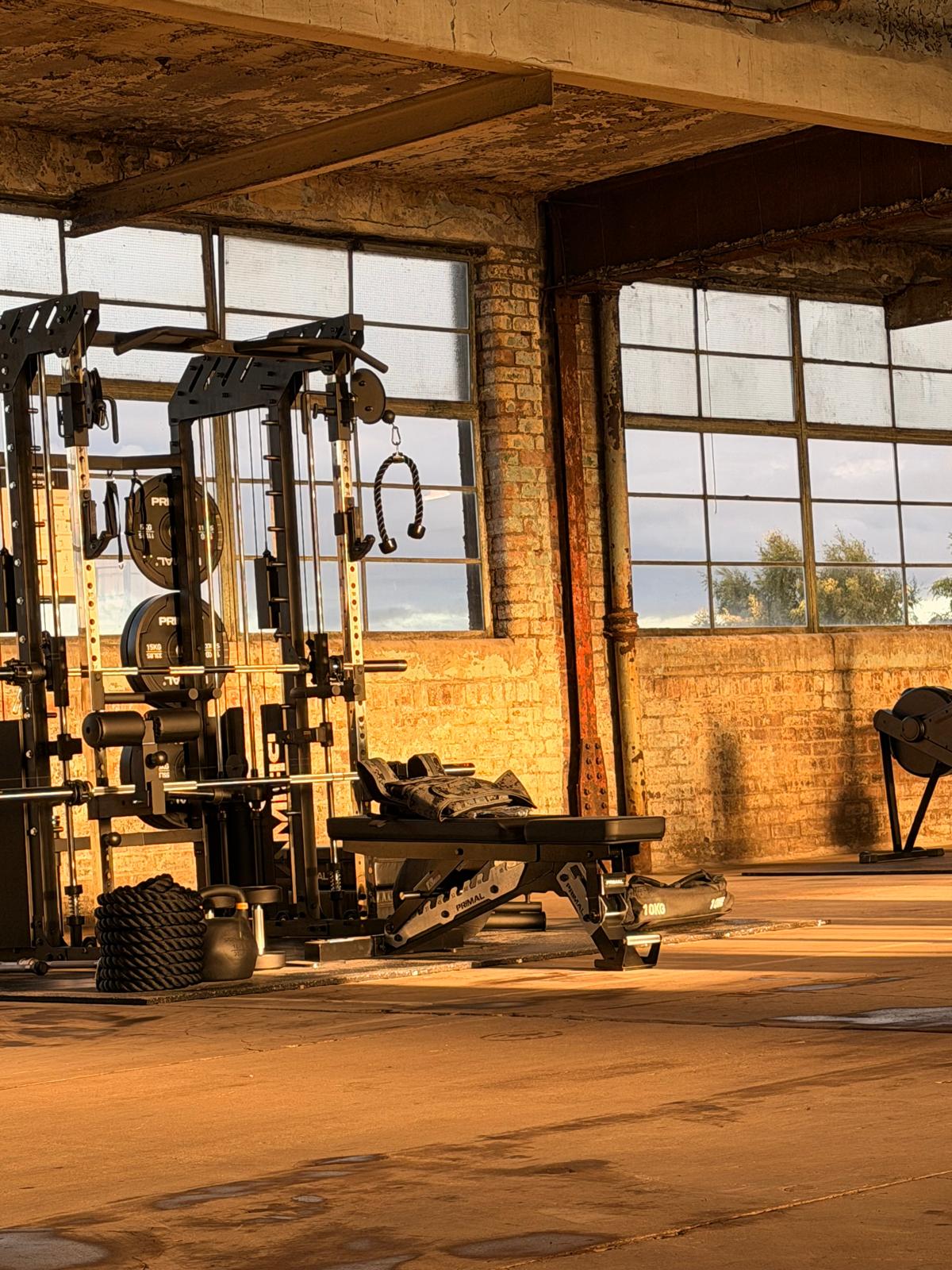 Gym equipment staged beside original factory windows at Eisen Hub